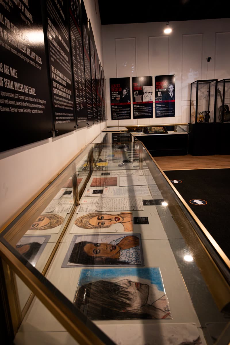 Display case of killers' letters and inmate portrait drawings