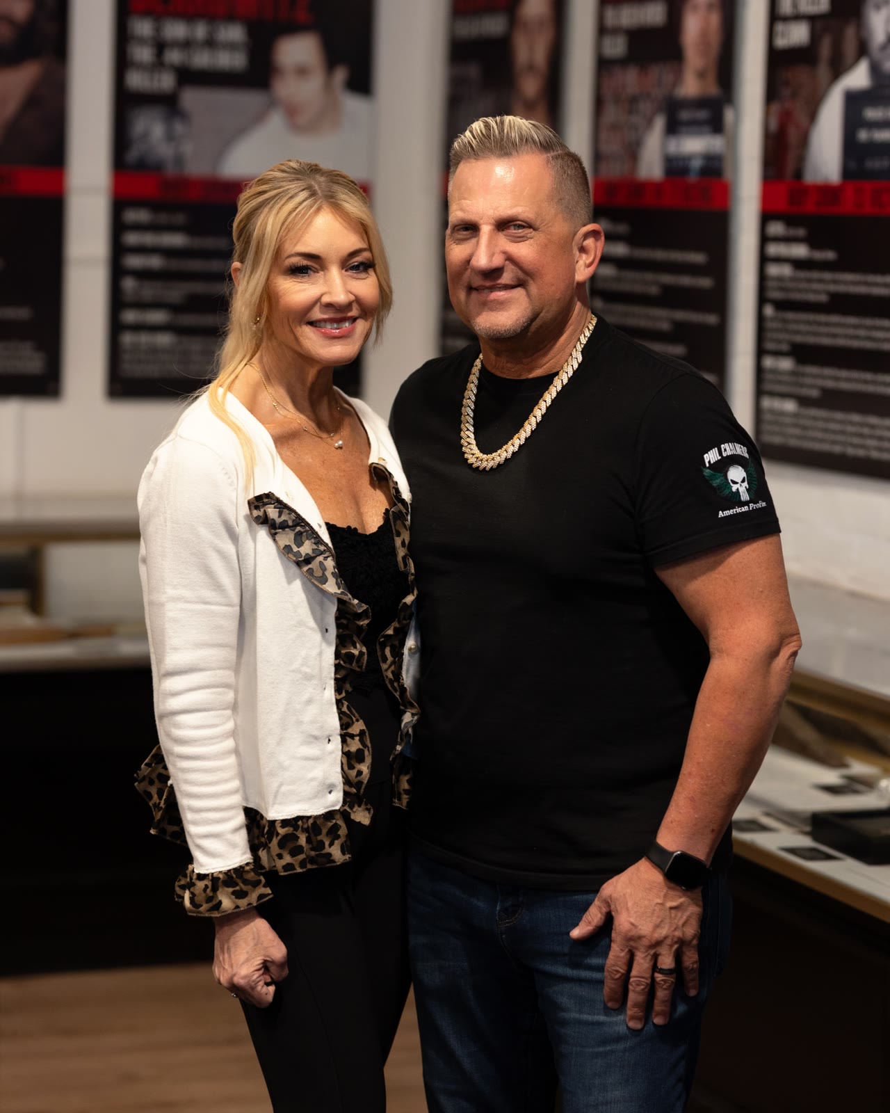 Phil and Wendi Chalmers, owners of the museum, in front of the exhibit wall